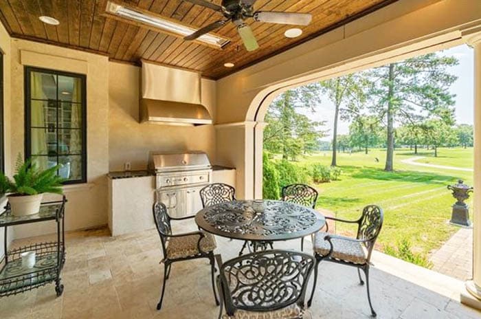 Outdoor kitchen patio with limestone tile flooring