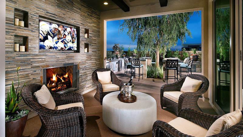 Covered luxury patio with outdoor living room stacked stone fireplace