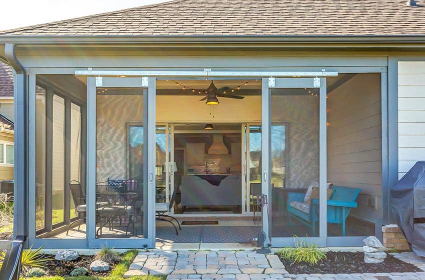 Enclosed patio design with sliding doors and screened walls