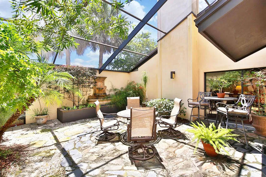 Glass slanted roof patio with textured concrete