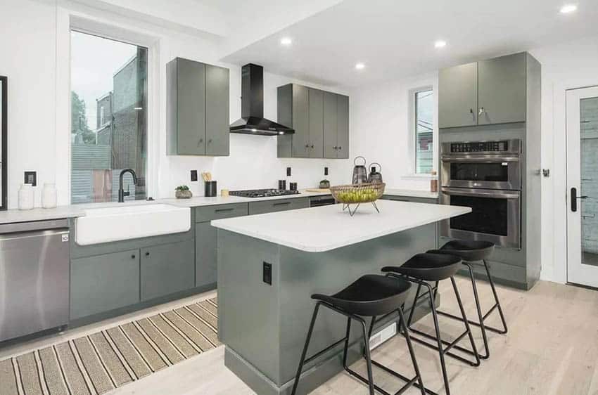 Gray cabinet kitchen with white quartz counters and black seating