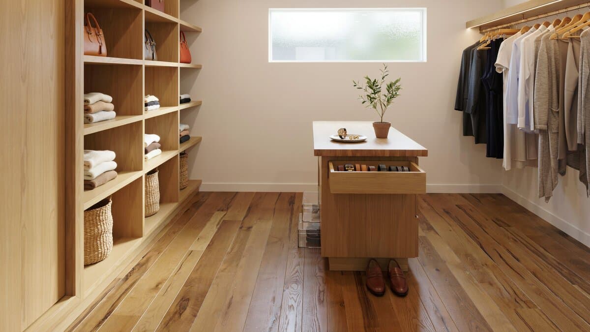 Hickory engineered wood floor in a walk in closet with open shelving and island