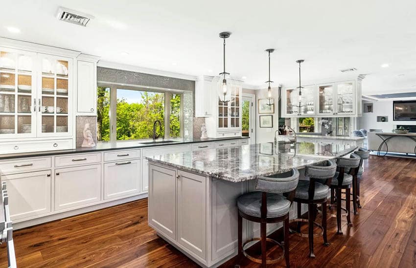 Kitchen with bay window above sink wood flooring