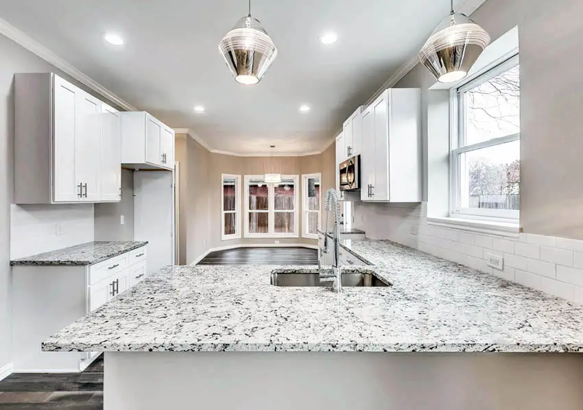 Kitchen with bay window dining nook, dallas white granite countertops and white shaker cabinets