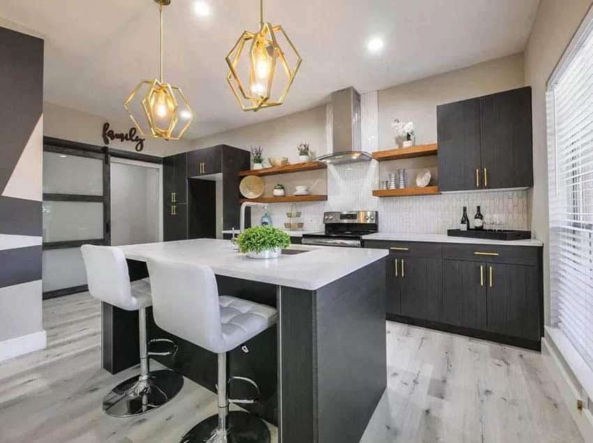 Kitchen with dark cabinets gold hardware and thick wall shelving 