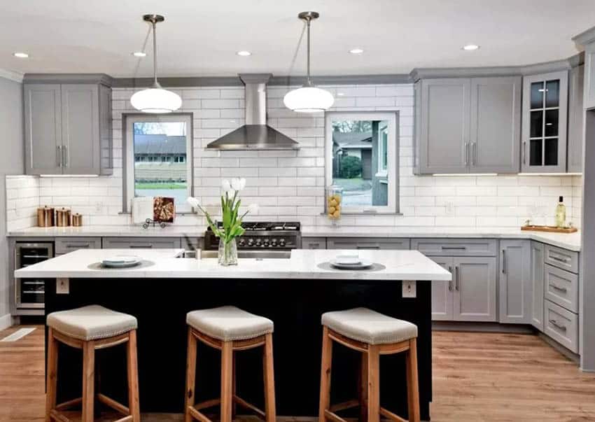Kitchen with gray cabinets dark wood island and wine tray decor