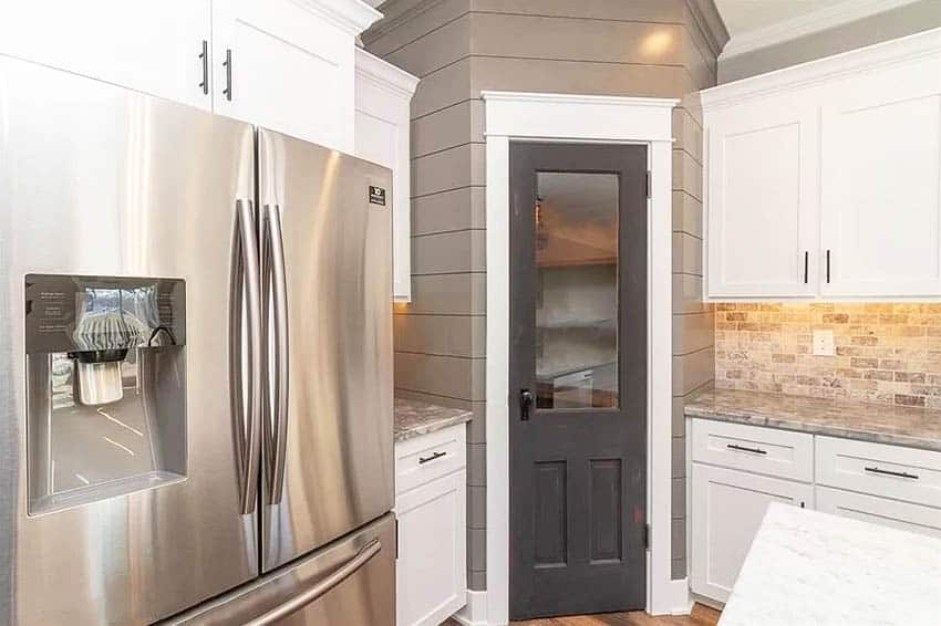 Kitchen with gray farmhouse pantry door with window