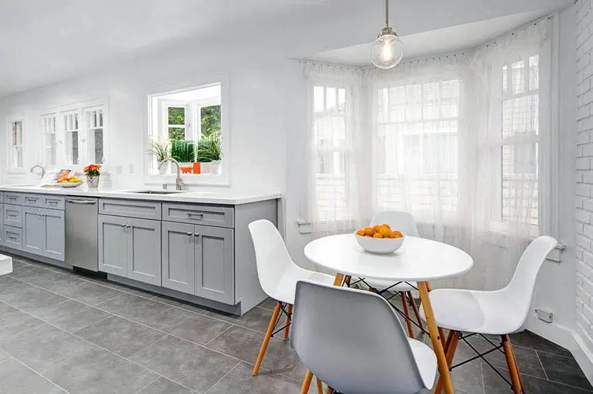 Kitchen with small bay window above sink and dining nook