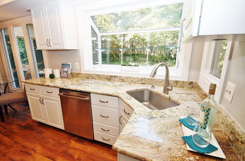 Kitchen with white cabinets bay window and yellow granite countertops