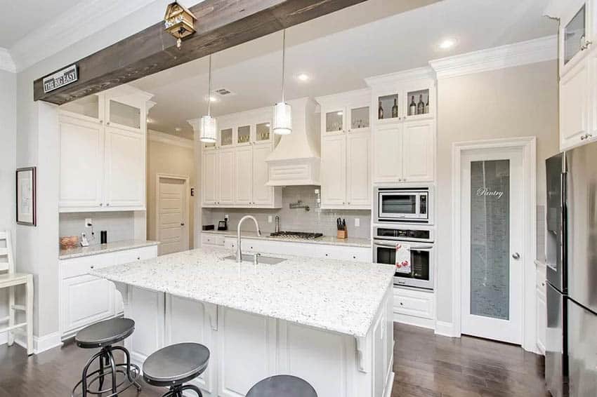 Kitchen with white cabinets glass pantry door