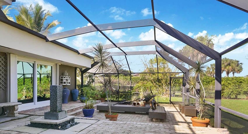 Large enclosed glass patio with interlocking pavers flooring