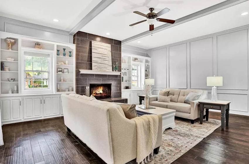 Living room with dark wood floors gray paint white built in cabinets