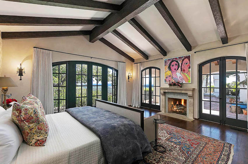 Mediterranean style bedroom with cathedral ceiling and wood beams