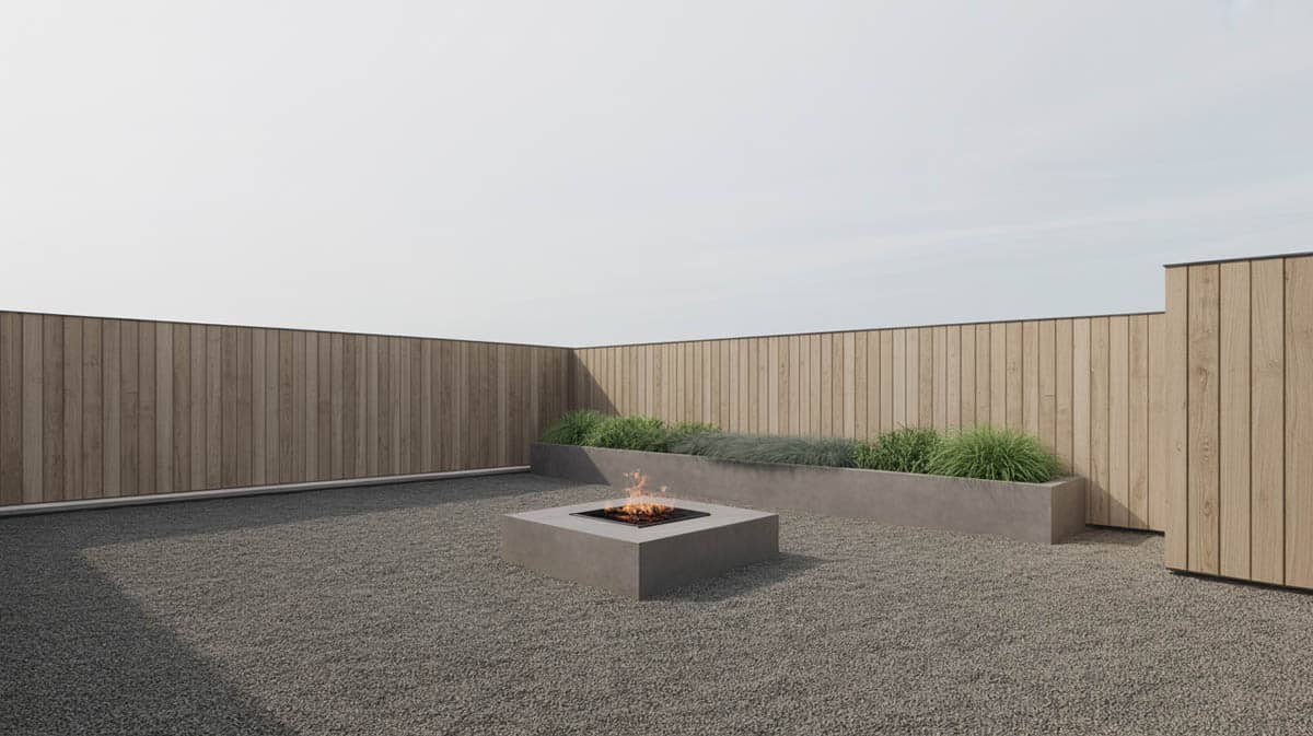 Minimalist modern backyard with fine crushed gray gravel and a square concrete fire pit