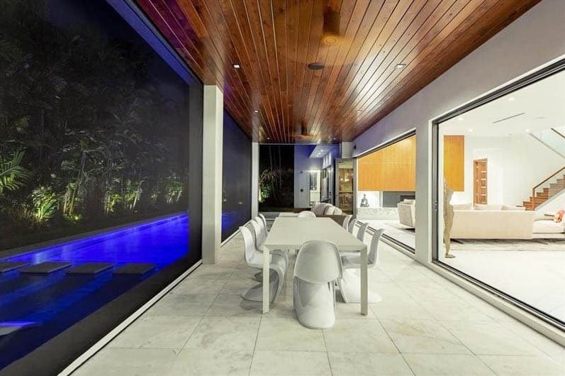 Modern enclosed pool patio with sliding doors and glass windows 