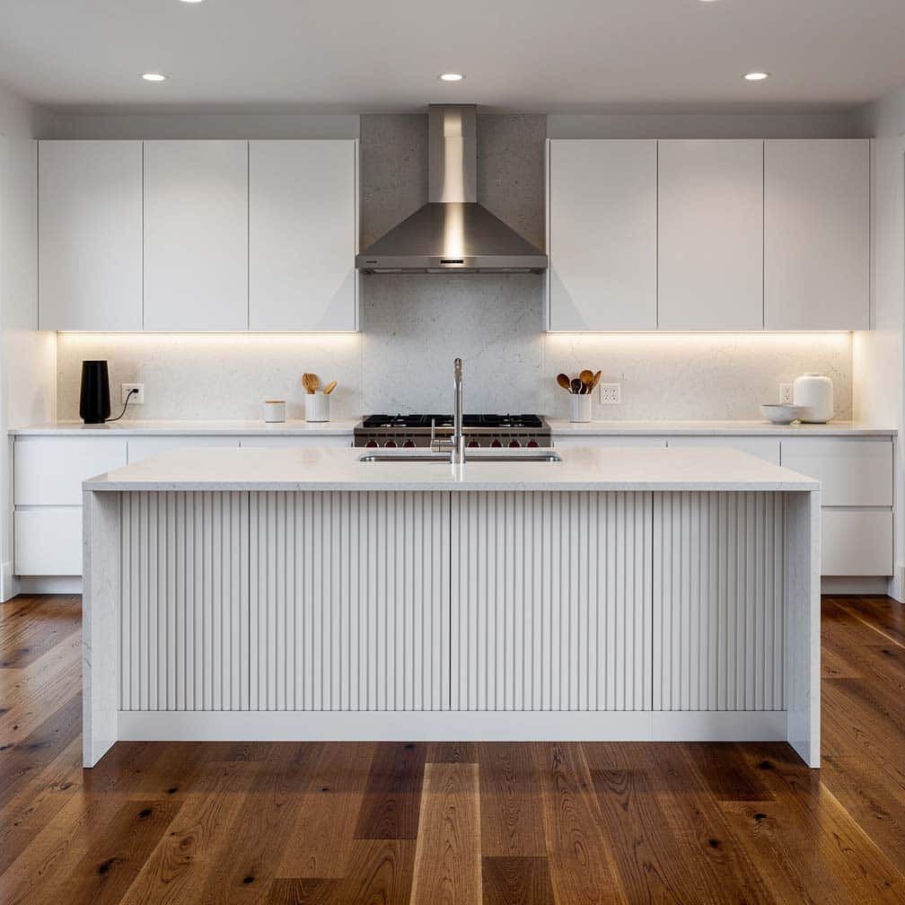 A kitchen with sleek cabinets, a stainless steel range hood, and wood flooring uses a beadboard