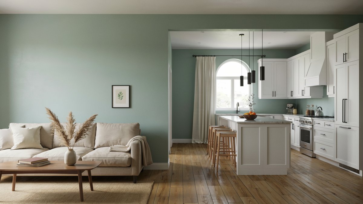 Sage green walls flow from living room into white open concept kitchen with island