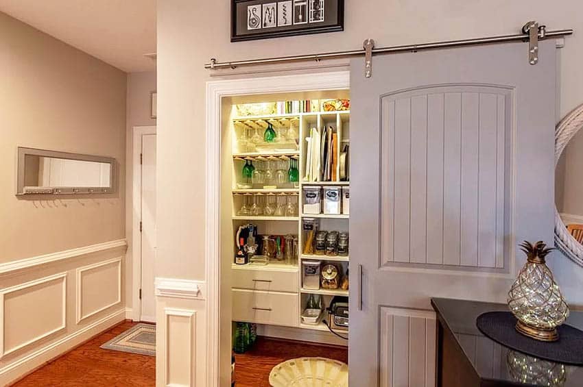 Rolling pantry door with custom storage cabinetry