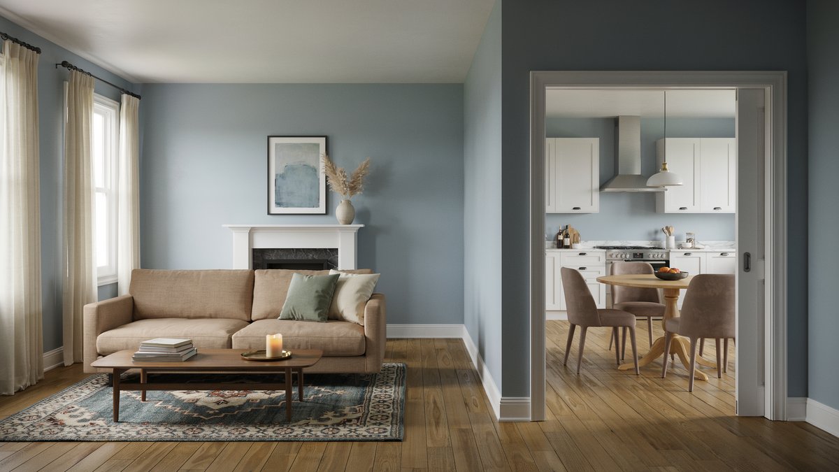 Soft blue gray living room with fireplace flowing into adjoining dining room and kitchen