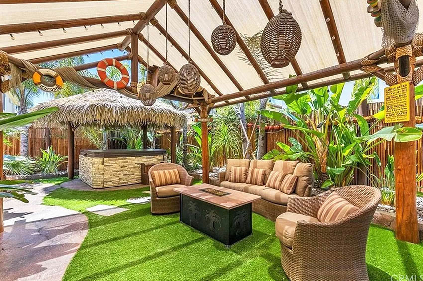 Tropical design patio with outdoor woven furniture and tiki bar