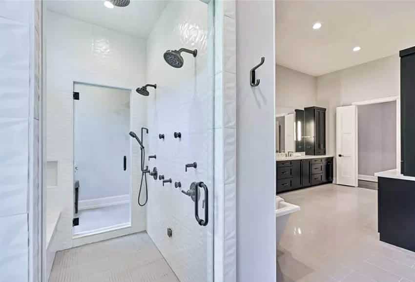 Walk through shower with wall mounted sprayer and rainfall shower head