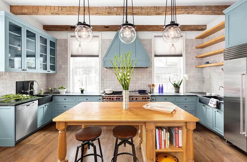 Beautiful country style kitchen with wood island, black quartz, plants and countertop decor