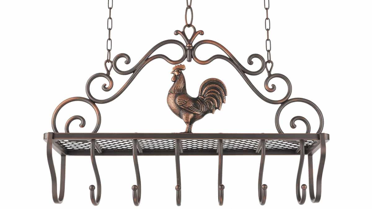 Ornate bronze hanging pot rack with decorative scrollwork and a cast rooster figurine as centerpiece