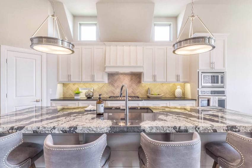 Stylish kitchen with quartz counter white shaker cabinets and decorative art pieces