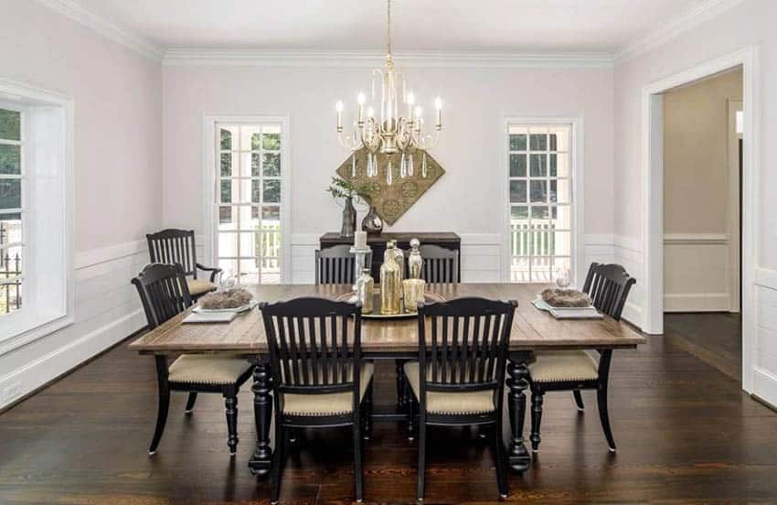 Dining room with chandelier, shiplap wainscoting, picture windows and wood flooring