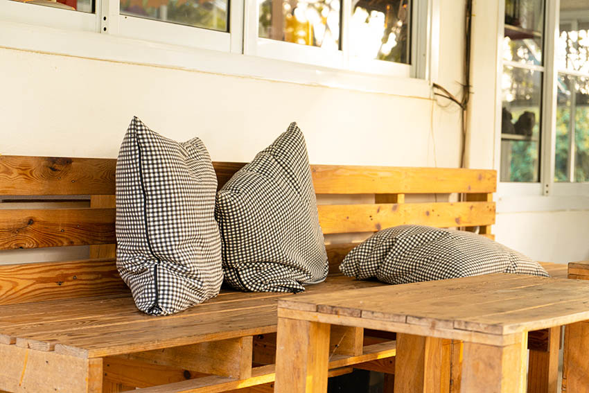 Bench and table with three checkered pillows