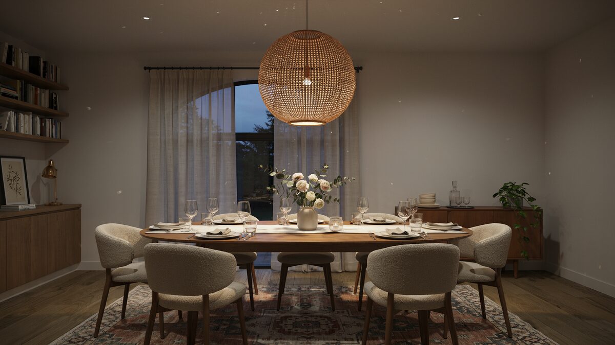 Woven rattan globe chandelier glowing above an oval dining table set for six