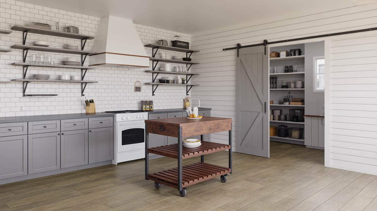 Gray shaker cabinets with black iron open shelves and a rustic rolling cart island beside a barn door