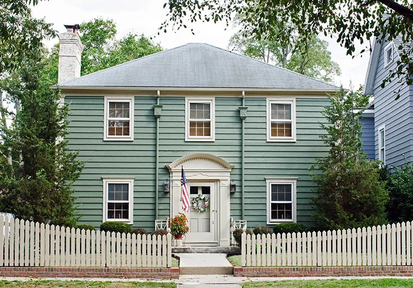 House with white door and white picket fence
