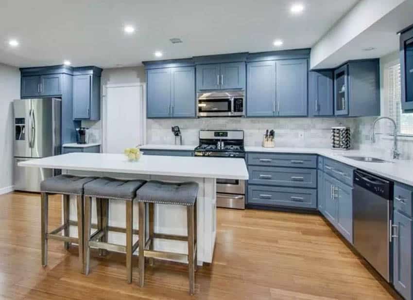 Kitchen with blue cabinets white island and spice rack