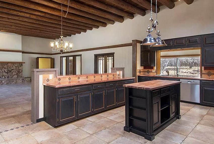 Kitchen with copper countertops, butcher block island and dark wood cabinets