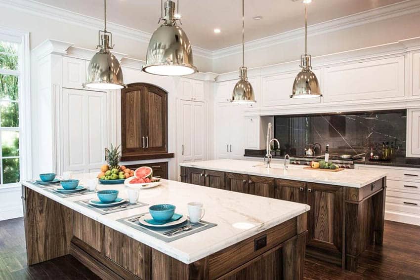 Kitchen with rustic wood islands with crema delicato marble countertops white cabinets