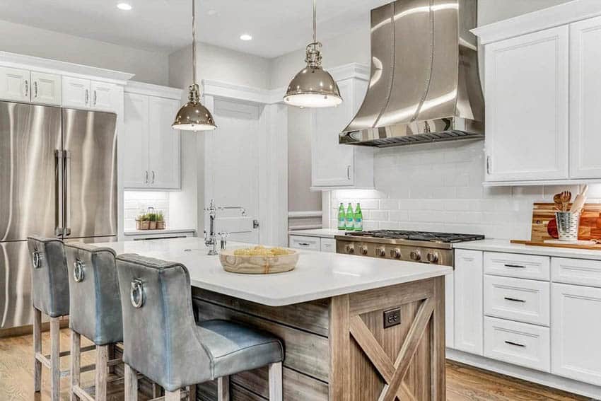 Kitchen with white cabinets reclaimed wood island pendant lights