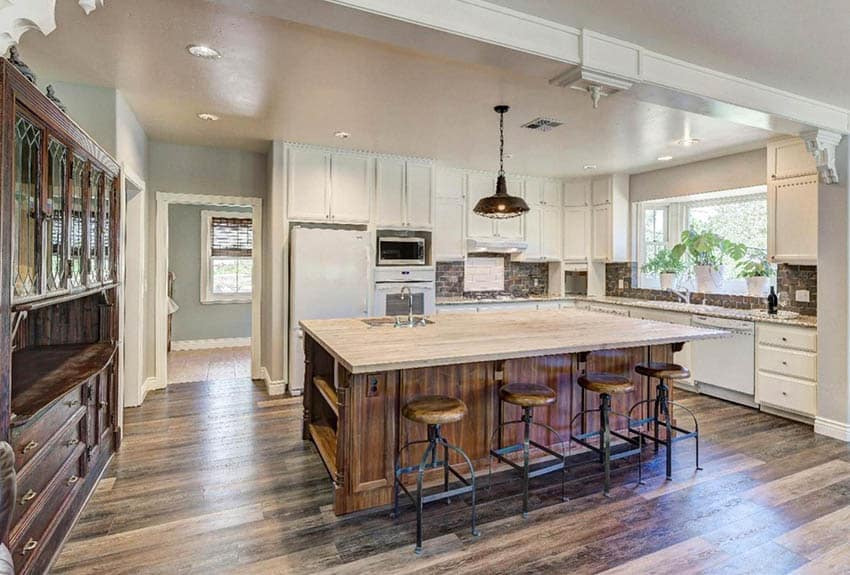 Kitchen with white cabinets rustic wood island with wood counters