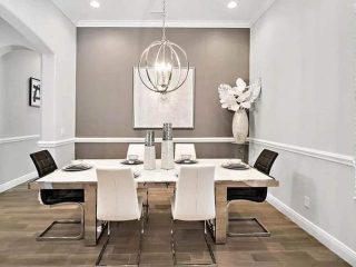 Modern dining room with globe chandelier chrome table chairs