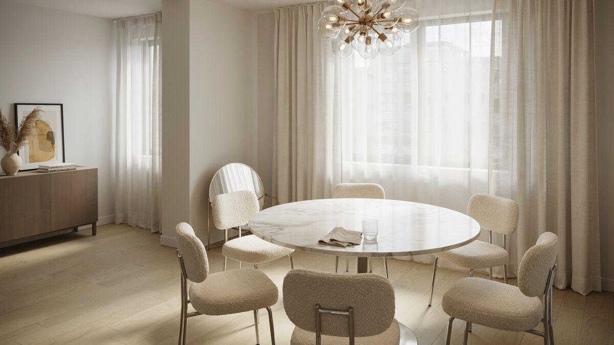 Modern dining room with a brass globe starburst chandelier round white table and cream chairs