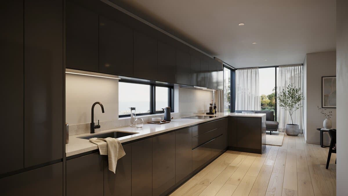 Long white quartz counter dividing a dark gloss kitchen from the living room