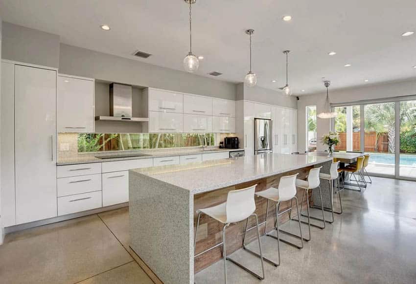 Modern kitchen with white cabinets light gray walls and gray concrete flooring