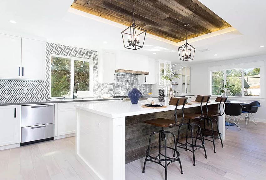 Open concept kitchen with distressed barn door wood island with white quartz countertop