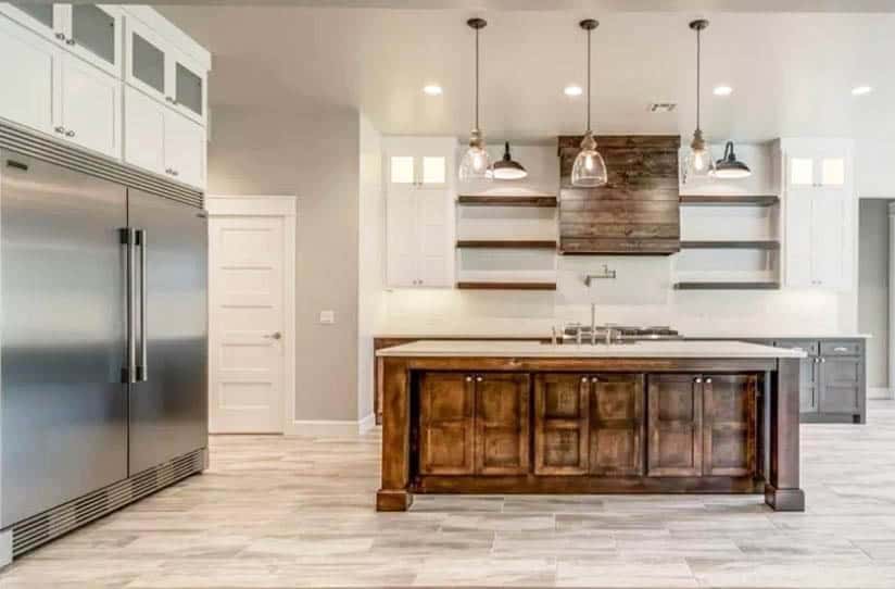 Open kitchen with wood island white and brown cabinets