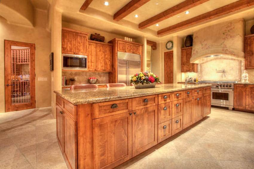 Rustic wood kitchen island with amber yellow granite countertops