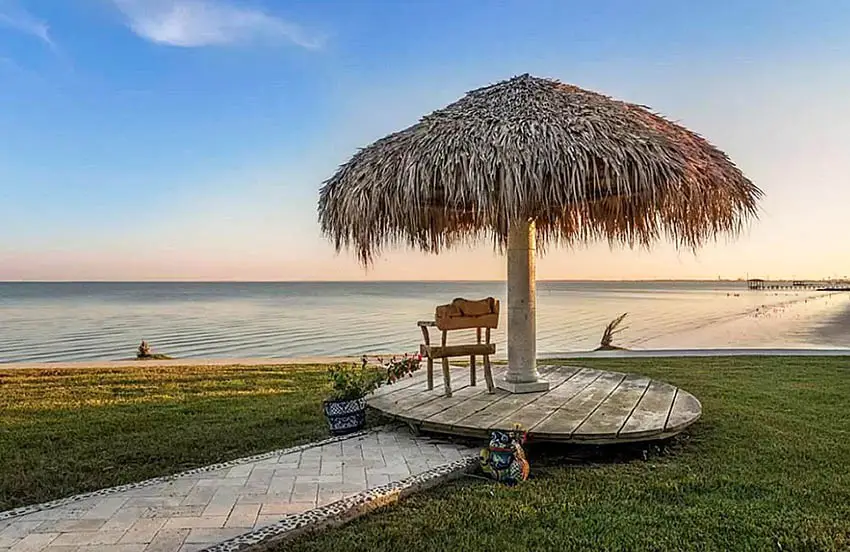 Single pole palapa structure with wood deck