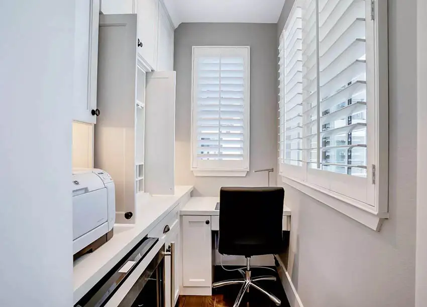 Narrow office with printer, black cabinet hardware and plantaiton shutters