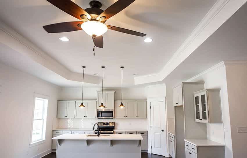 Tray ceiling design with fan in open concept kitchen living room