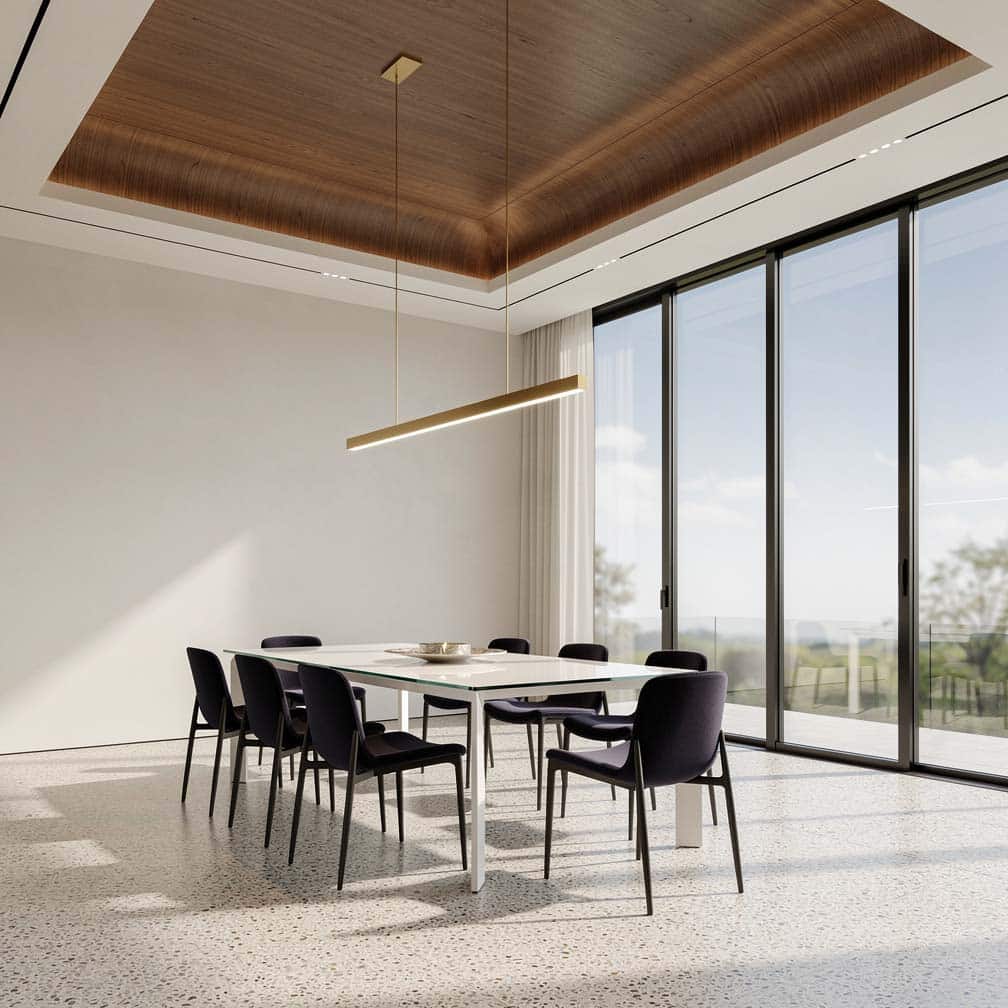Modern dining room with wood veneer accent panels and linear pendant lighting above a white glass table.