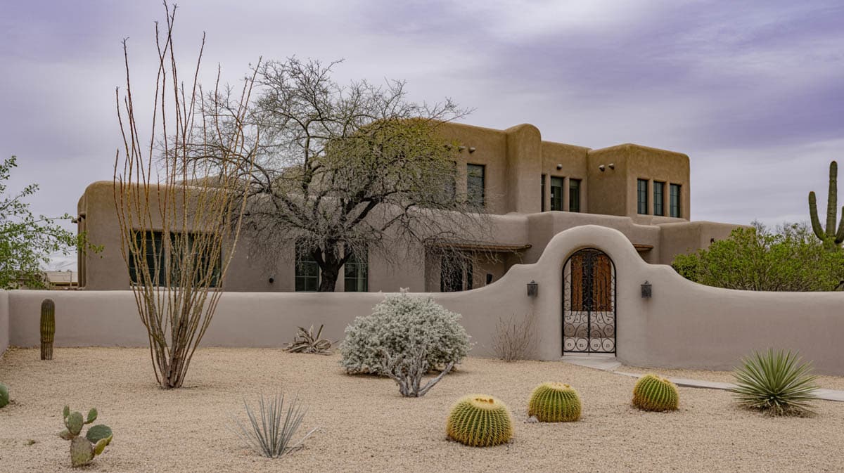 Home with gravel yard dry riverbedand barrel cactus bougainvillea